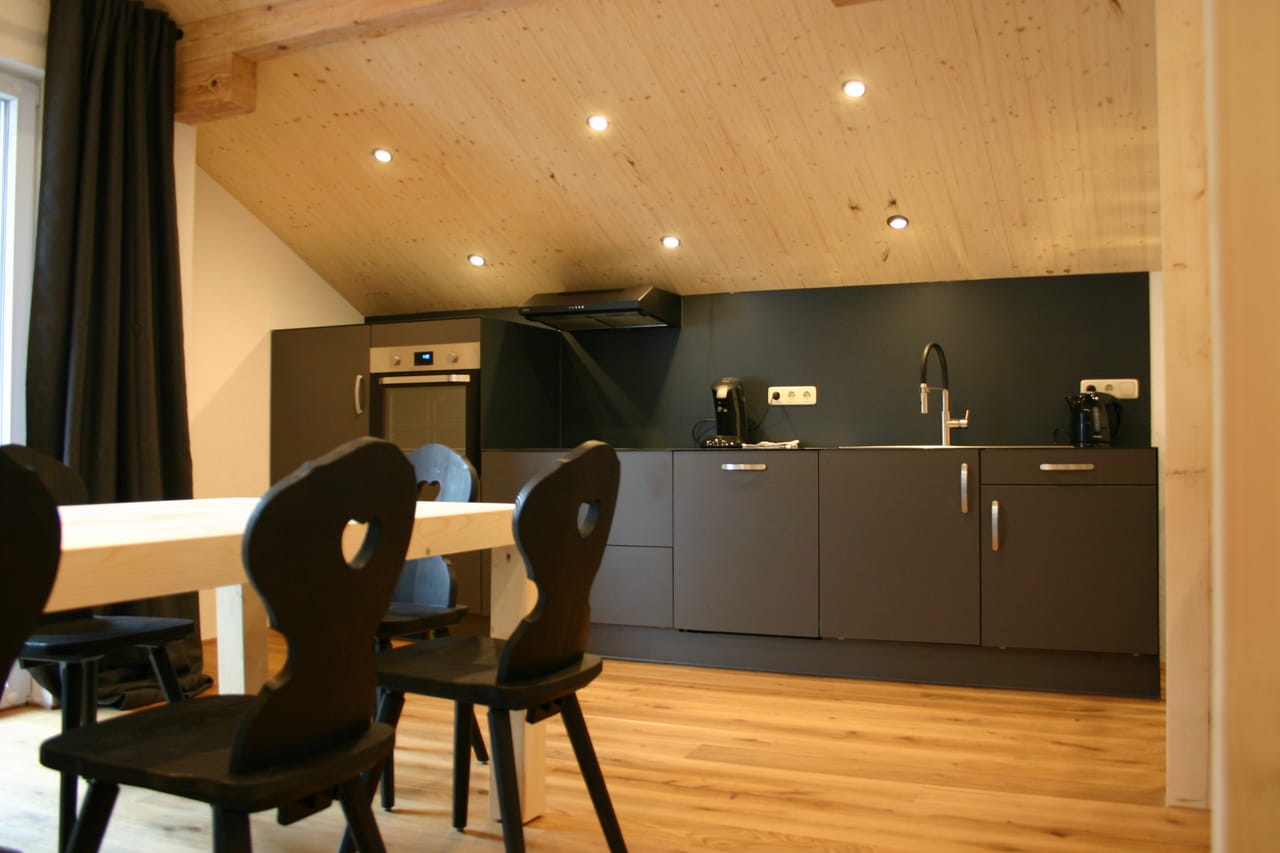 Open kitchen-living room with dining table in MOChalet 04 at the MONTAFONLodge