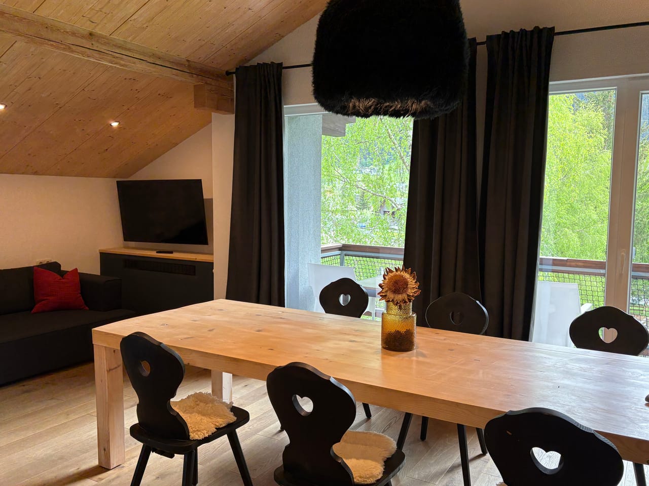 Dining area with a long table and shelf in MOChalet 06 at the MONTAFONLodge